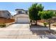 Charming two-story home featuring a neutral color palette, spacious garage, and mature trees at 15054 N 173Rd Dr, Surprise, AZ 85388