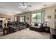 Inviting living room featuring plush seating, neutral carpet, and large window with backyard views at 15054 N 173Rd Dr, Surprise, AZ 85388
