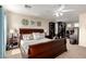 Spacious main bedroom features soft carpet, ceiling fan, and classic furniture at 15054 N 173Rd Dr, Surprise, AZ 85388