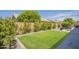 Serene backyard offering a lush lawn, mature trees, and a peaceful outdoor retreat at 1562 E Gleneagle Dr, Chandler, AZ 85249