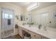 Primary bathroom featuring double sinks with vanity, large mirror, and a separate toilet room at 1562 E Gleneagle Dr, Chandler, AZ 85249