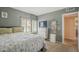 Comfortable bedroom featuring a bed, dresser with television, and window with shutter blinds at 1562 E Gleneagle Dr, Chandler, AZ 85249