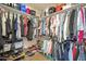 Organized walk-in closet featuring shelving, hanging racks, and ample storage space for clothes and shoes at 1562 E Gleneagle Dr, Chandler, AZ 85249