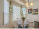 Bright eat-in kitchen area with hanging pothos and white chairs at 1562 E Gleneagle Dr, Chandler, AZ 85249