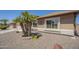 Lovely desert home with attractive landscaping, including mature palm trees and decorative stone accents at 1562 E Gleneagle Dr, Chandler, AZ 85249