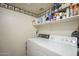 Laundry room featuring a washer and dryer, storage shelves, and stylish decor at 1562 E Gleneagle Dr, Chandler, AZ 85249