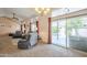 Bright living area with cozy seating, decorative windows, and direct access to the outdoor patio at 1562 E Gleneagle Dr, Chandler, AZ 85249