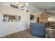 Open concept living space with a view of the kitchen through a pass-through window, vaulted ceiling and fan at 1562 E Gleneagle Dr, Chandler, AZ 85249