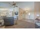 Inviting living room with vaulted ceilings, neutral paint, a fan and plush seating area with TV at 1562 E Gleneagle Dr, Chandler, AZ 85249