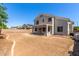 View of the home's backyard with block fence, covered patio, and area prepped for desert landscaping at 15808 N 164Th Ln, Surprise, AZ 85388