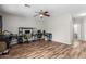 Spacious bedroom with wood floors, modern ceiling fan, and plenty of natural light for a warm atmosphere at 15808 N 164Th Ln, Surprise, AZ 85388