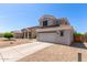 Two-story home featuring neutral paint, tile roof, and a spacious two-car garage with low maintenance landscaping at 15808 N 164Th Ln, Surprise, AZ 85388