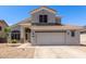 Two-story home featuring neutral paint, tile roof, and a spacious two-car garage with desert landscaping at 15808 N 164Th Ln, Surprise, AZ 85388