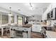 Open-concept kitchen with white cabinets, stainless appliances, and a center island that overlooks the dining area at 15808 N 164Th Ln, Surprise, AZ 85388