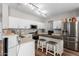 This spacious kitchen is complete with white cabinets, stainless steel appliances, and center island seating at 15808 N 164Th Ln, Surprise, AZ 85388