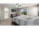 Relaxing bedroom with large windows and a television, adjoined to the main bathroom with double sinks at 15808 N 164Th Ln, Surprise, AZ 85388