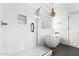 Modern bathroom with a frameless glass shower, soaking tub, and stylish chandelier at 17290 N 170Th Ln, Surprise, AZ 85374