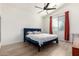 Bright bedroom featuring a plush blue bed frame, wood floors, and lots of natural light at 17290 N 170Th Ln, Surprise, AZ 85374