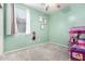 Cozy bedroom with neutral carpet, mint colored walls and natural light from the window at 17290 N 170Th Ln, Surprise, AZ 85374