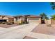 Attractive single-story home features a two-car garage and low-maintenance desert landscaping for easy living at 17290 N 170Th Ln, Surprise, AZ 85374