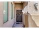 Inviting front entrance with a secure screen door and a welcoming doormat at 17290 N 170Th Ln, Surprise, AZ 85374