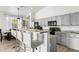 Cozy kitchen featuring stainless steel appliances, a breakfast bar with seating, and bright natural light at 17290 N 170Th Ln, Surprise, AZ 85374