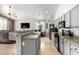 Open concept kitchen featuring stainless steel appliances, a breakfast bar with seating, and views to the living room at 17290 N 170Th Ln, Surprise, AZ 85374