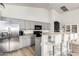 Well-lit kitchen featuring stainless steel appliances, gray cabinets, and a breakfast bar with seating at 17290 N 170Th Ln, Surprise, AZ 85374