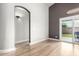 Bright living room with gray walls, sliding glass door, and an archway to another room at 17290 N 170Th Ln, Surprise, AZ 85374