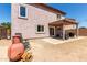 Spacious backyard featuring a covered patio, stucco wall and ample space for outdoor activities at 1753 E Maddison Cir, San Tan Valley, AZ 85140