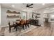 Bright dining area with wood floors and decorative shelves, flowing into the open kitchen at 1753 E Maddison Cir, San Tan Valley, AZ 85140