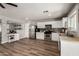 Modern kitchen with stainless steel appliances, white cabinets, and an adjacent dining area at 1753 E Maddison Cir, San Tan Valley, AZ 85140