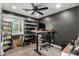 Well-lit home office featuring dark accent wall, adjustable standing desk, and natural light at 1753 E Maddison Cir, San Tan Valley, AZ 85140