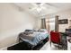 Cozy bedroom with a ceiling fan, window, and workspace with a comfortable red chair at 20419 N 34Th St, Phoenix, AZ 85050