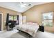 A spacious bedroom has large windows, a desk, and soft, neutral tones for a peaceful atmosphere at 20419 N 34Th St, Phoenix, AZ 85050
