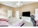 A cozy bedroom featuring a bed, TV, dresser and ensuite bathroom with a great source of natural light at 20419 N 34Th St, Phoenix, AZ 85050