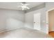 A bedroom with neutral carpet, a ceiling fan, and a door to the hallway with a view of a second bedroom at 20419 N 34Th St, Phoenix, AZ 85050