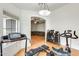 A versatile home gym area featuring an exercise bench, treadmill, bike, and a view to a Gathering room with a brown couch at 20419 N 34Th St, Phoenix, AZ 85050