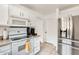 Galley kitchen featuring white cabinets, stainless steel appliances, and a range at 20419 N 34Th St, Phoenix, AZ 85050