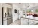Stainless steel refrigerator and breakfast bar, part of a bright eat-in kitchen at 20419 N 34Th St, Phoenix, AZ 85050