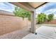 Covered patio with a decorative rock feature and a neutral block fence at 20419 N 34Th St, Phoenix, AZ 85050