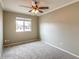 Neutral bedroom featuring a ceiling fan and window offering natural light at 2110 E Kathleen Rd, Phoenix, AZ 85022