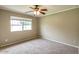Neutral bedroom featuring a ceiling fan and window offering natural light at 2110 E Kathleen Rd, Phoenix, AZ 85022