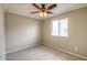 Neutral bedroom featuring a ceiling fan and window offering natural light at 2110 E Kathleen Rd, Phoenix, AZ 85022