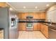 Well-appointed kitchen with stainless steel appliances, tile backsplash, and natural wood cabinets at 2110 E Kathleen Rd, Phoenix, AZ 85022