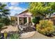 Serene backyard featuring a dining table and chairs, patio, and lush desert landscaping at 21573 N 261St Ave, Buckeye, AZ 85396