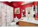 This red bathroom features modern fixtures, decorative accents, and is bathed in bright light at 21573 N 261St Ave, Buckeye, AZ 85396