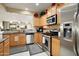 Spacious kitchen featuring stainless appliances, granite countertops, and ample cabinet storage at 21573 N 261St Ave, Buckeye, AZ 85396