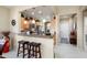 Eat-in kitchen with stainless steel appliances, pendant lights, and breakfast bar with seating at 21573 N 261St Ave, Buckeye, AZ 85396
