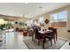 Inviting living area with tile flooring, large windows, and access to the outdoor patio at 21573 N 261St Ave, Buckeye, AZ 85396